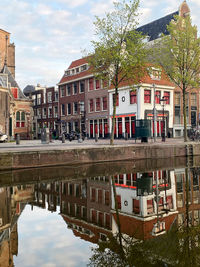 Reflection of building in canal against sky