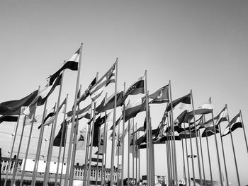 Low angle view of flags against clear sky