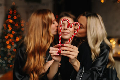 Happy funny girls celebrate christmas holidays and new year in a cozy house