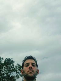 Portrait of young man against sky