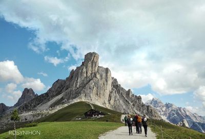 People on mountain against sky