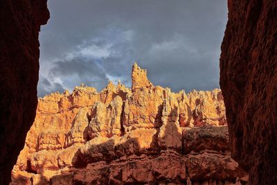 Low angle view of rock formation against sky