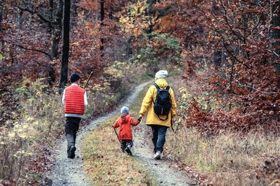 Rear view of woman walking on footpath