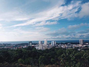 High angle view of city against cloudy sky