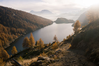 Scenic view of river amidst mountains against sky