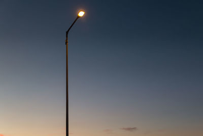 Low angle view of street light against sky at sunset