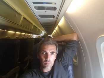 Portrait of man traveling in airplane