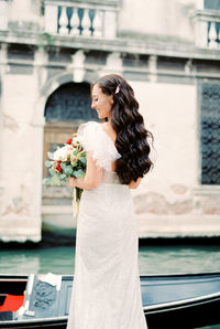 Side view of woman holding bouquet