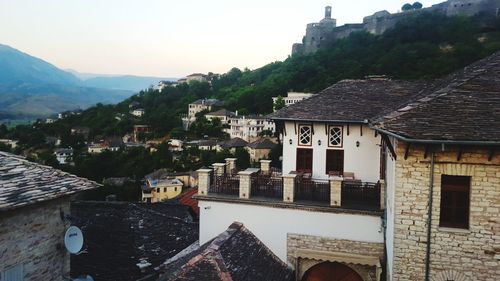 Houses in town against clear sky