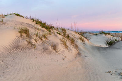 Scenic view of beach against sky during sunset