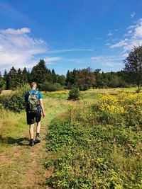 Full length of man walking on land against sky