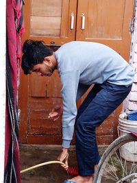 Rear view of man working at entrance