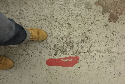 Low section of woman standing on tiled floor