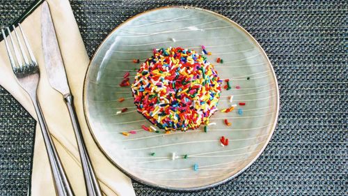 High angle view of candies in plate on table