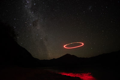 Scenic view of lake against star field at night