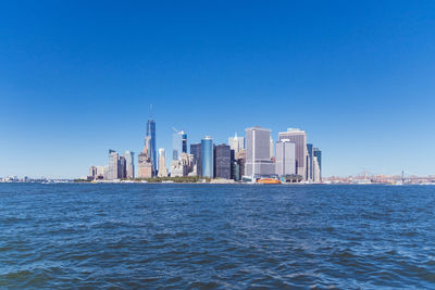 View of cityscape against clear blue sky