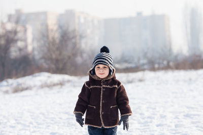 Portrait of man standing in snow