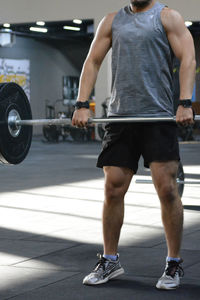 Low section of man exercising in gym