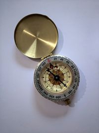 High angle view of compass over white background