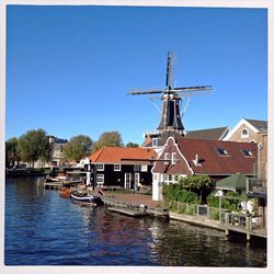 Ship in river against clear blue sky