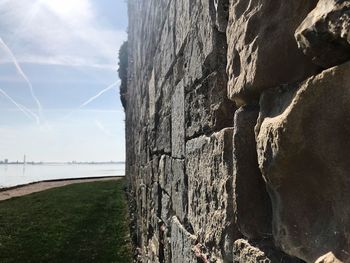 Rock formations by sea against sky