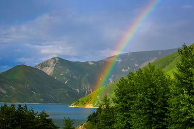 Rainbow over lake kezenoy-am in the mountains of chechnya