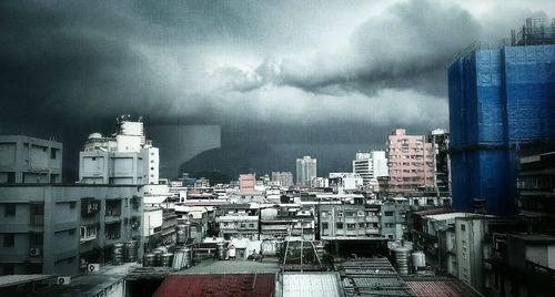 Cityscape against cloudy sky