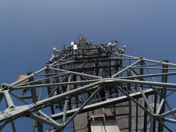 Low angle view of communications tower against clear sky