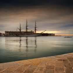 View of harbor against cloudy sky