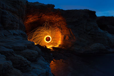 Illuminated wire wool at rock formation