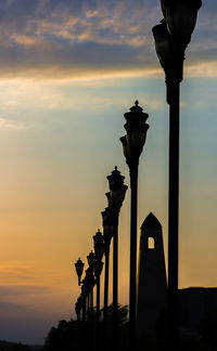 Silhouette of street lights during sunset