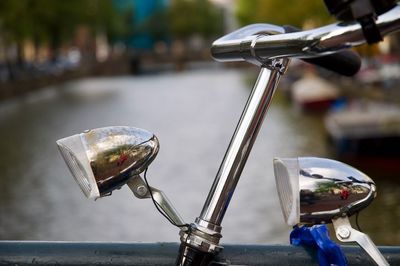 Close-up of bicycle against canal