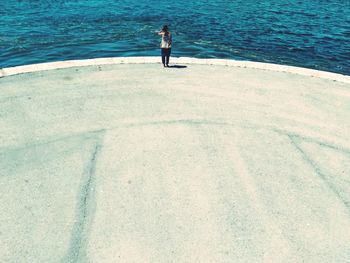 High angle view of woman standing on beach