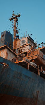 Rusty ship against clear blue sky