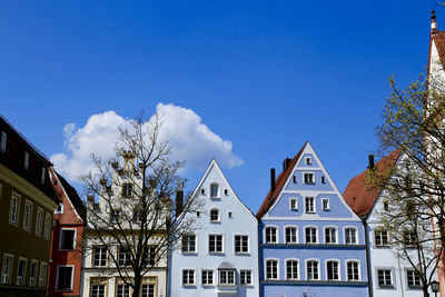 Low angle view of buildings against blue sky