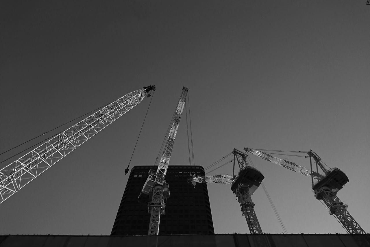 low angle view, crane - construction machinery, clear sky, sky, construction site, built structure, metal, city, no people, outdoors, architecture, industry, construction, night