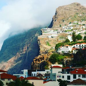 High angle view of townscape by mountain against sky