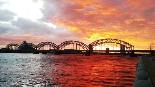 View of bridge over sea against cloudy sky