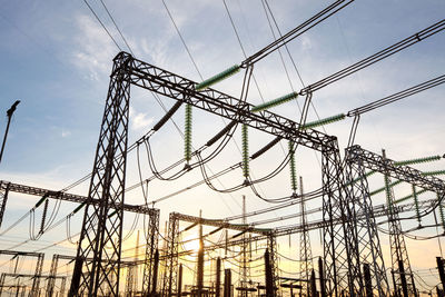 Low angle view of electricity pylon against sky