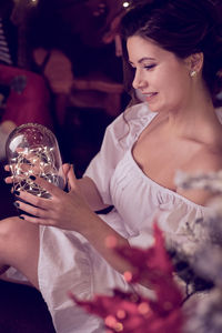 Portrait of young woman drinking glass