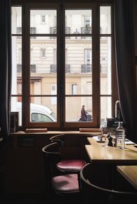 Chairs and tables arranged by window in restaurant