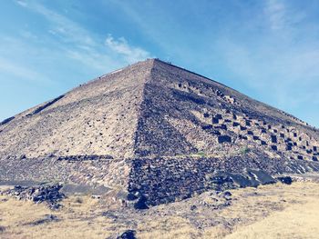 Low angle view of old building against cloudy sky