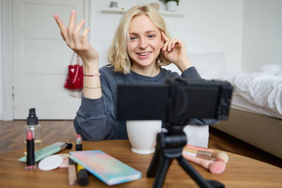 Portrait of young woman using mobile phone