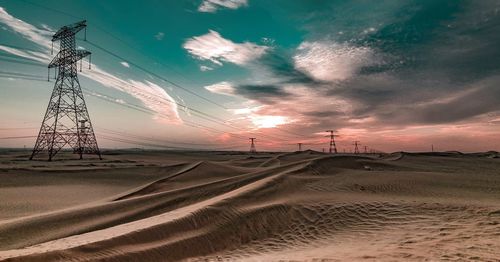 Rural desert scene against dramatic sunset sky