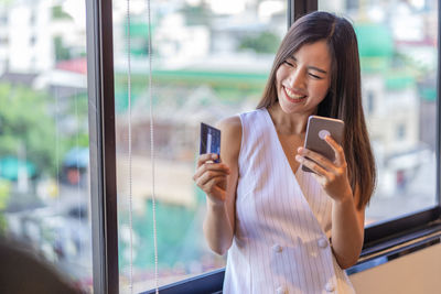 Young woman using phone