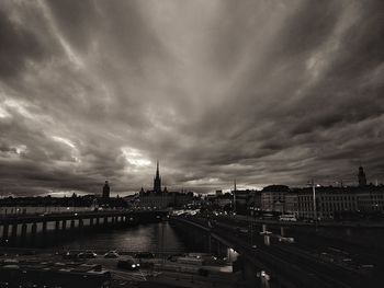 Bridge over river against buildings in city