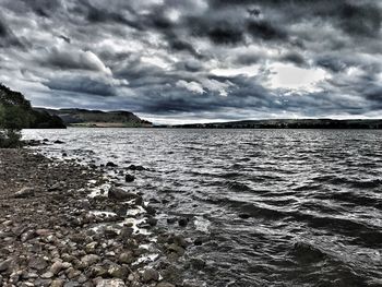 Scenic view of sea against cloudy sky