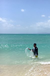 Full length of man on beach against sky