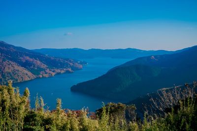 Scenic view of mountains against blue sky