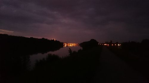 Reflection of trees in water at night